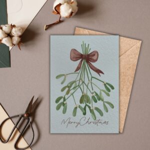 Pippin Prints Mistletoe Merry Christmas Card pack of 5 cards mock up image to show card in a festive flat lay setting