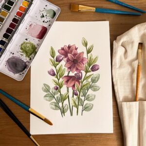 Photo from above above of purple Spring Bouquet original artwork by Pippin Prints surrounded by watercolour paint palette and paint brushes
