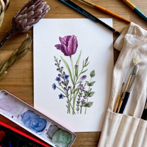 Purple Spring Flowers Original Watercolour Painting by Pippin Prints, lying flat on my desk in my studio surrounded by paints and paint brushes.